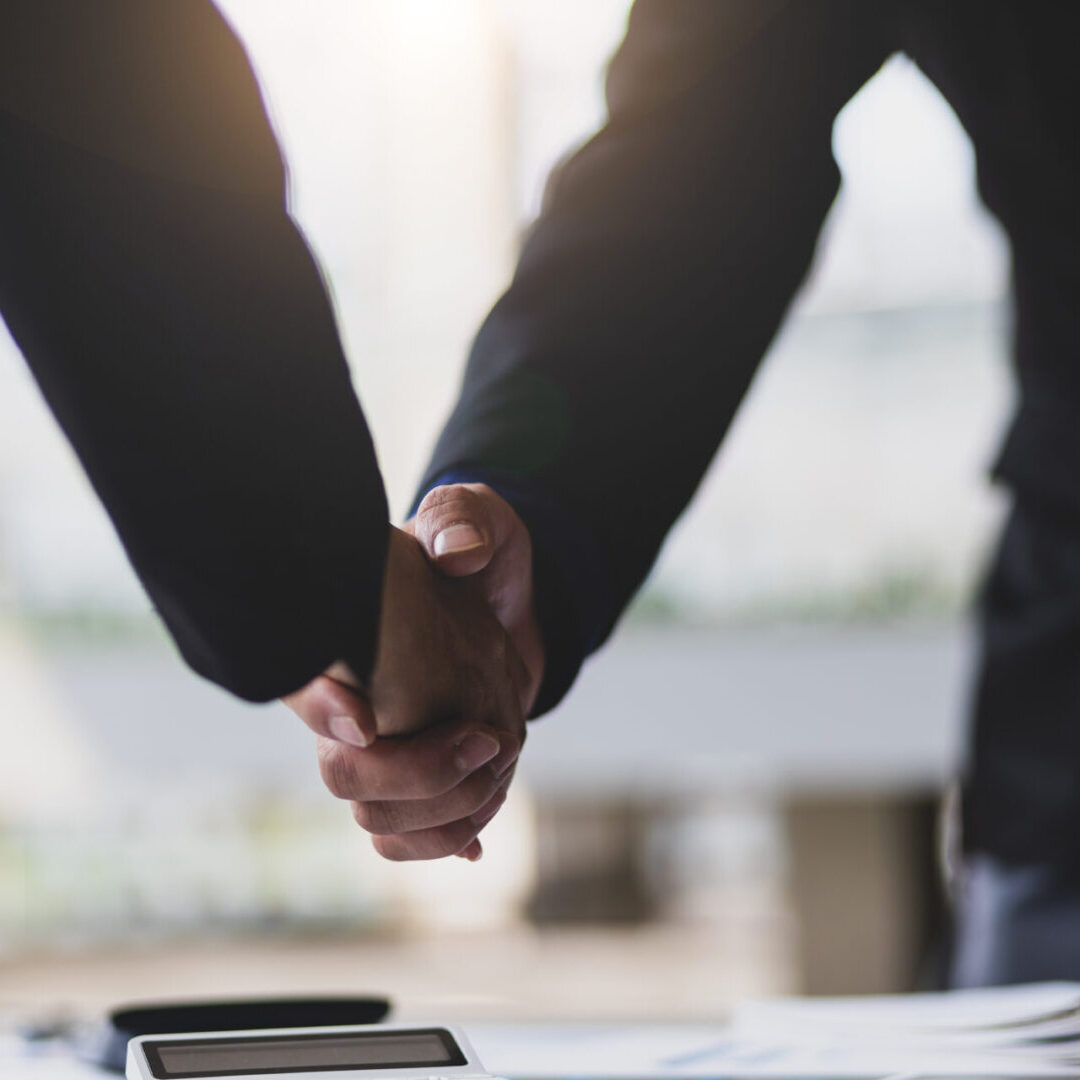 Handshake. Business people shaking hands with business partners after business planning analysis meeting.